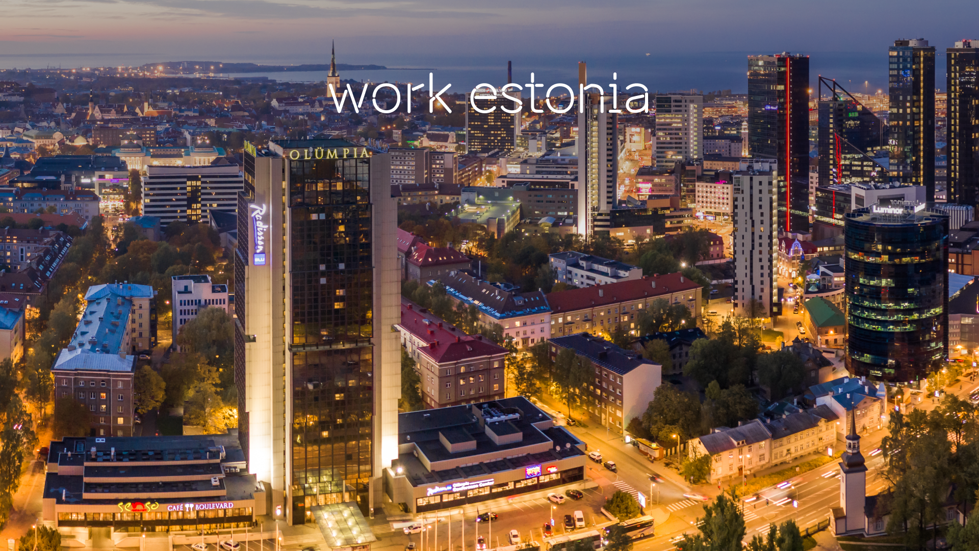Skyline of Tallinn City at night with overlay written work in Estonia